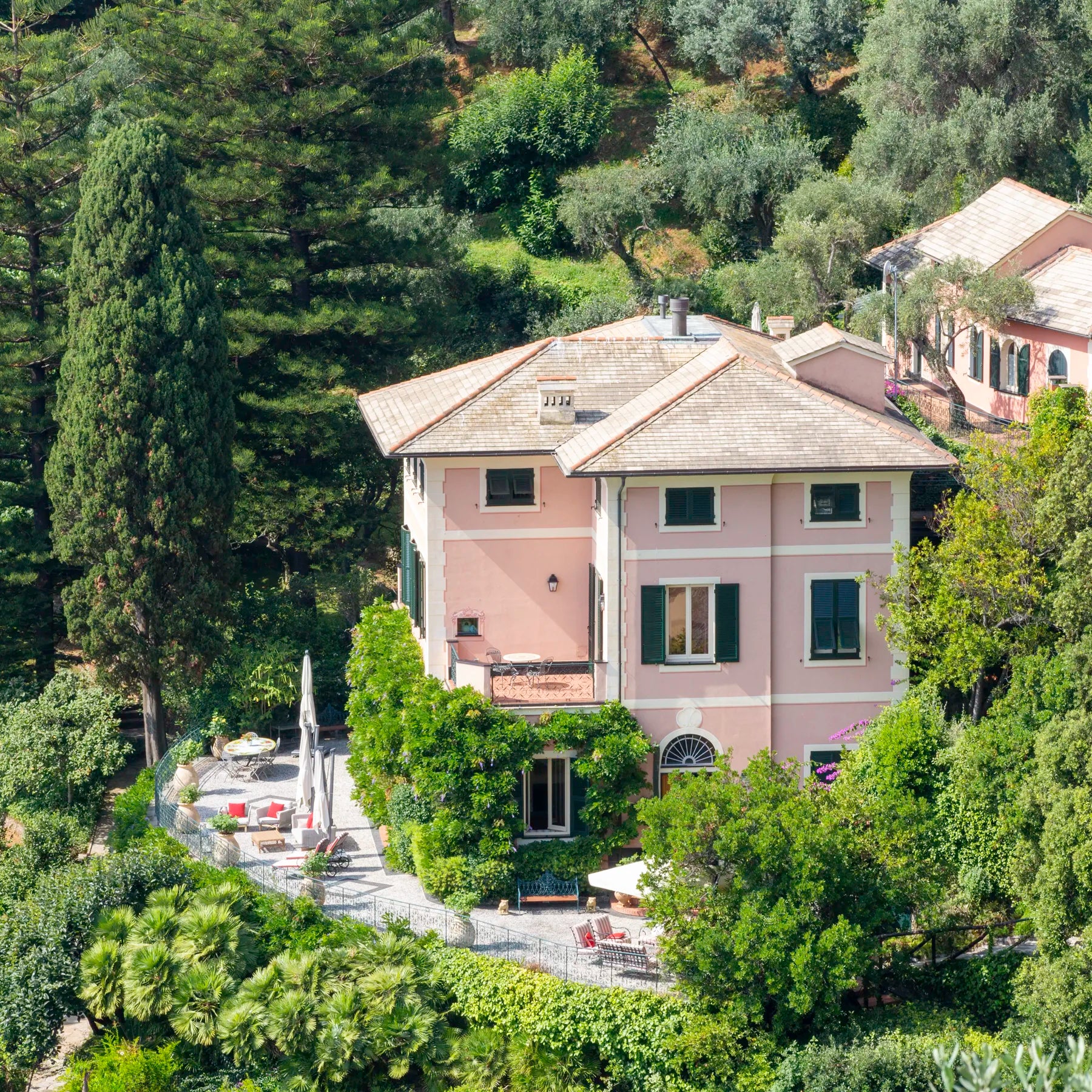 Large pink villa in Portofino surrounded by trees and greenery