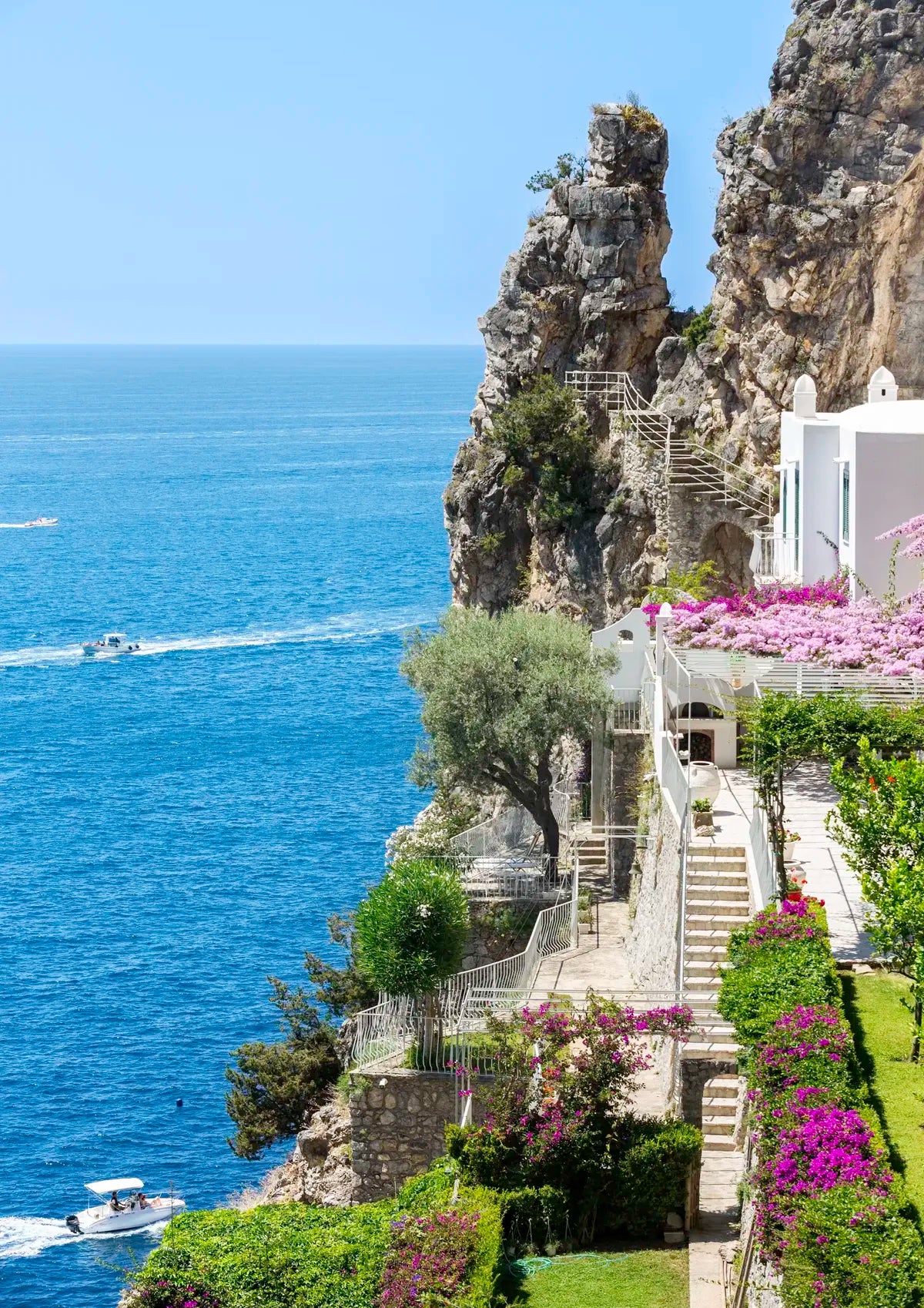 Staircase leading to a scenic coastal location with ocean view and rocky cliffs.