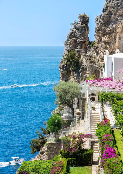 Staircase leading to a scenic coastal location with ocean view and rocky cliffs.