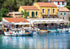 Beautiful Kioni harbour scene with boats and colorful buildings in a coastal town.