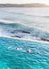 Person swimming in an ocean pool with ocean waves in the background