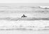 Female surfer paddling out to surf