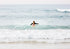 Female surfer paddling out to surf