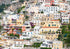 Hilly residential area with closely packed houses in a coastal town.