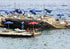 Rocky platform with lounge chairs and sun umbrellas next to the ocean
