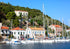 Kioni harbour with sailboats and buildings on a hillside under a clear blue sky.