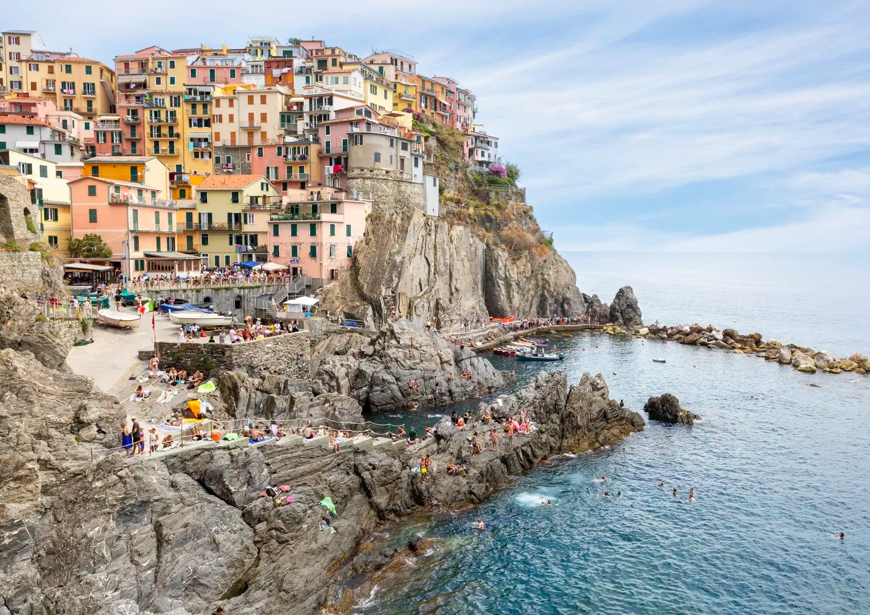 Scenic view of a coastal town with buildings on cliffs overlooking the sea.