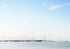 Sailing boats on a calm body of water with a clear sky
