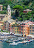 Hilly town with colorful buildings and a harbor filled with boats.