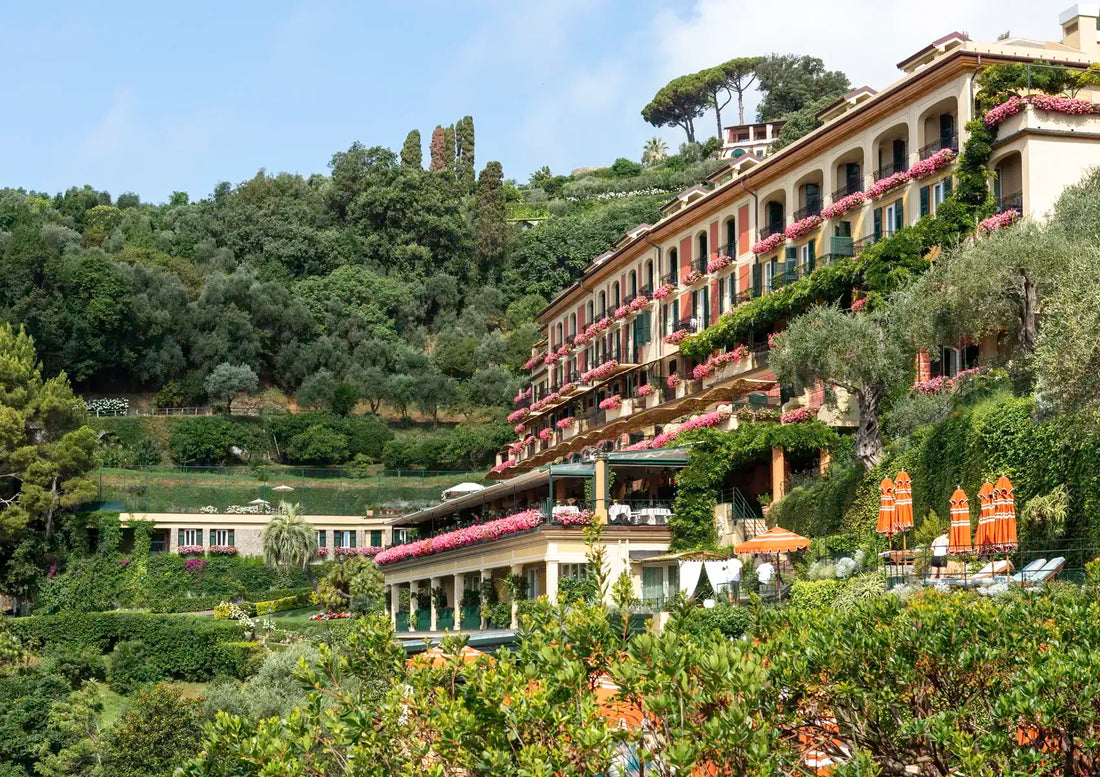 Luxury hotel on a hillside with greenery and clear sky
