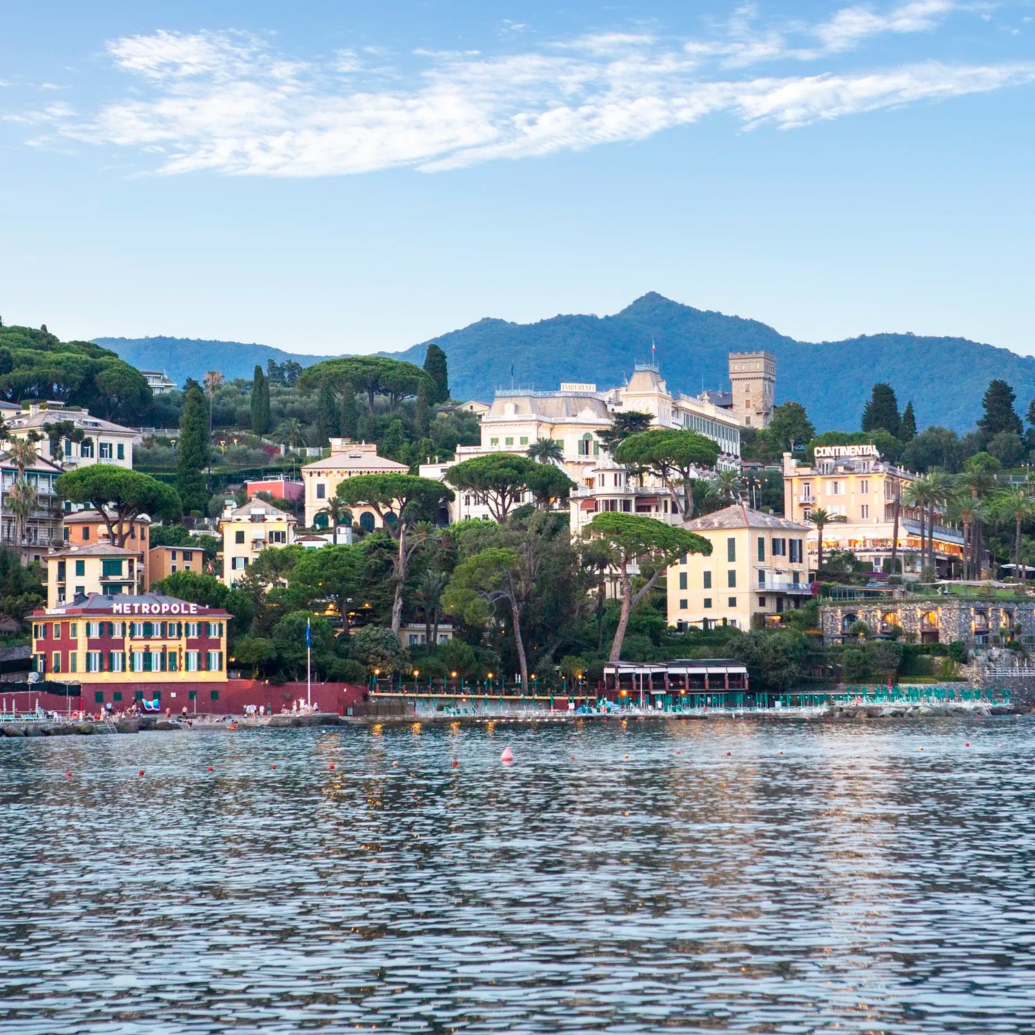 Village by the water with mountains in the background