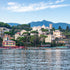 Village by the water with mountains in the background