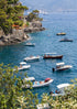Boats in a harbor with a scenic view of mountains and trees.