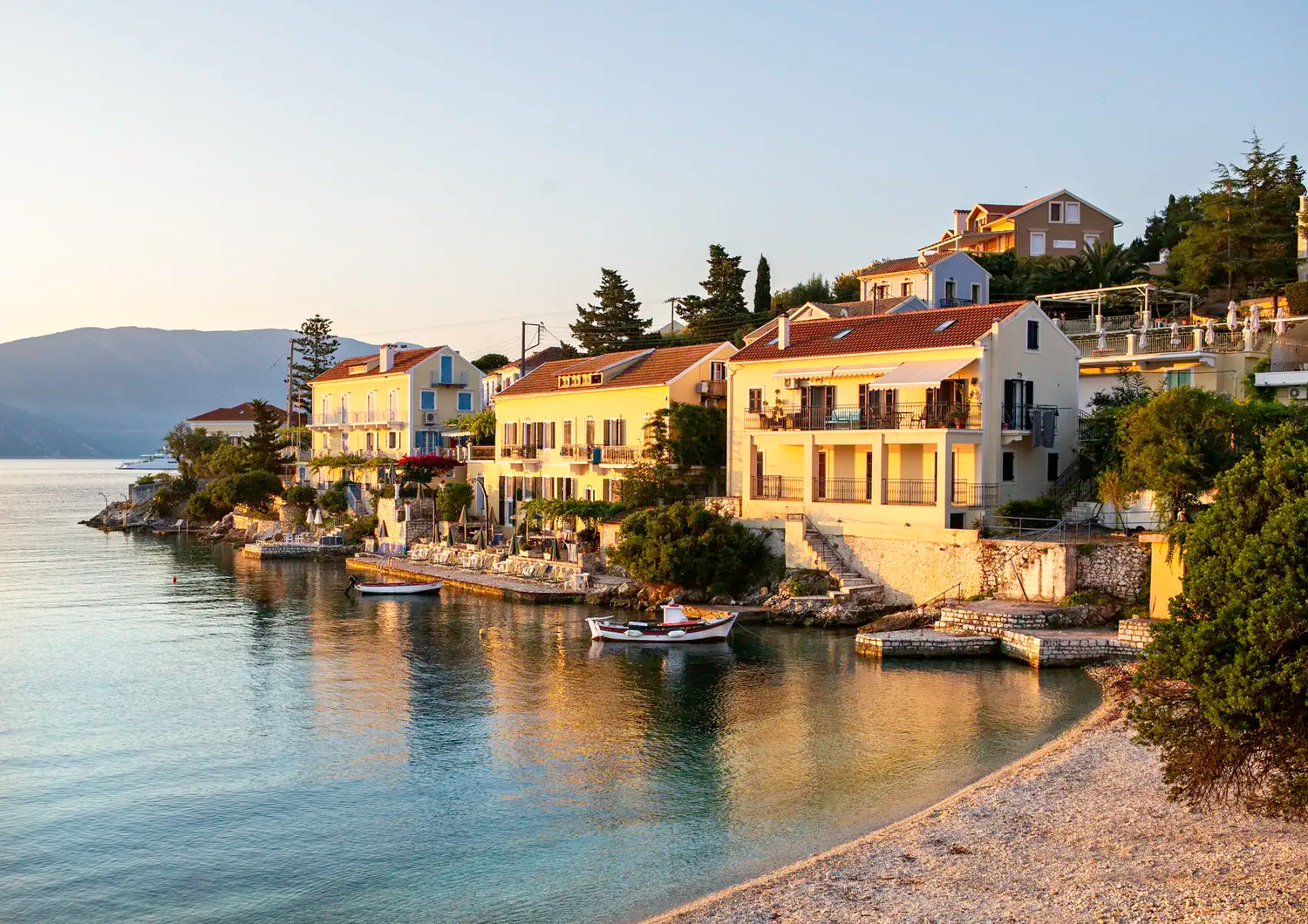 Coastal town with houses by the sea during sunset