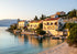 Coastal town with houses by the sea during sunset
