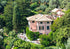 Large pink villa surrounded by lush greenery