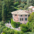 Large pink villa in Portofino surrounded by trees and greenery
