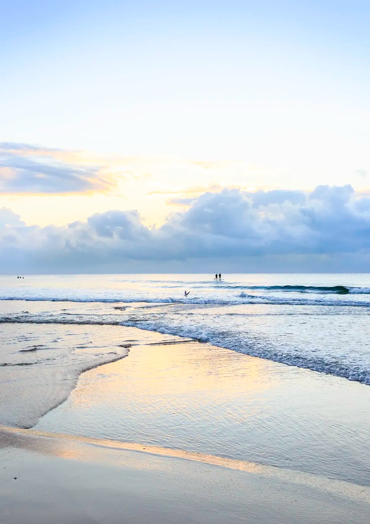 Beach scene with waves and a cloudy sky