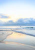 Beach scene with waves and a cloudy sky