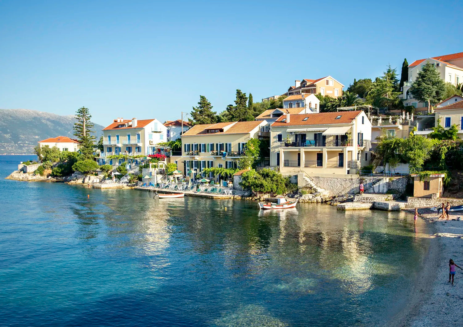 Coastal village with houses by the water on a clear day